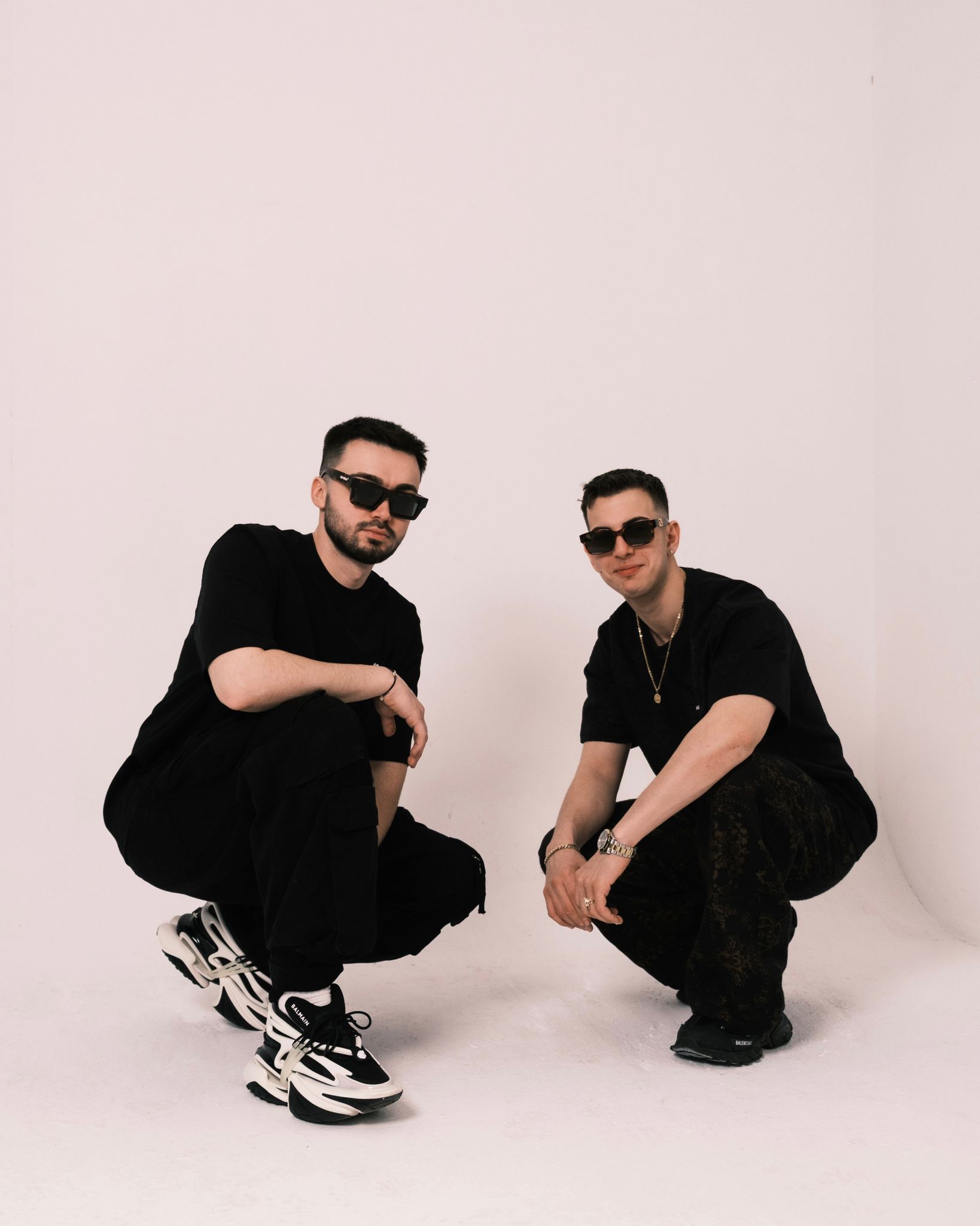Studio photograph of 2side in black outfits